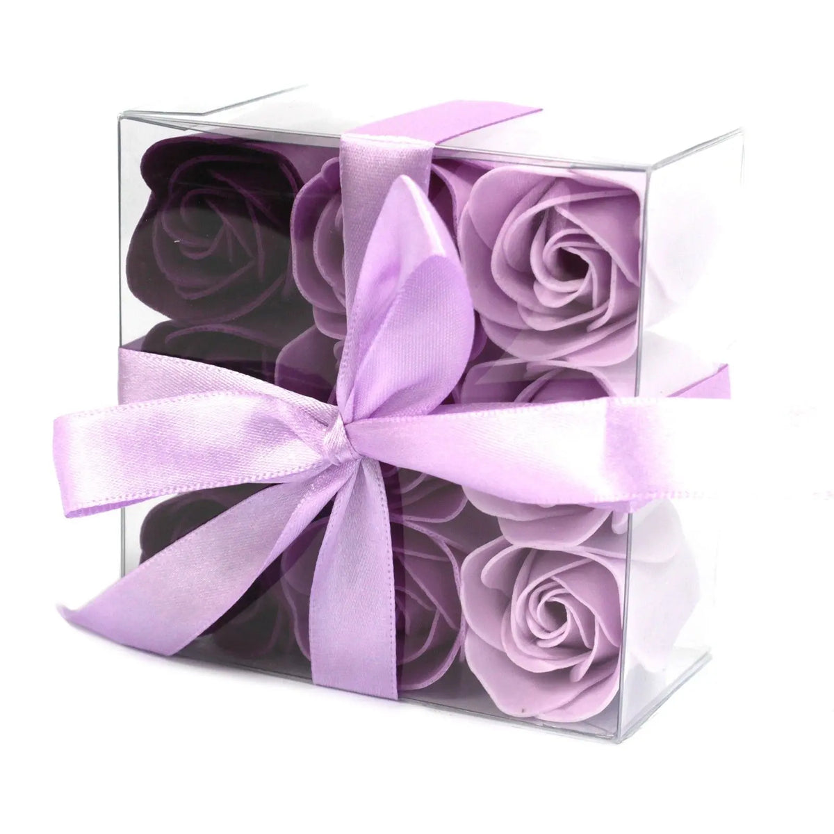 Caja transparente con 9 rosas de jabón en tonos lavanda y violeta, decorada con un elegante lazo de cinta lila.