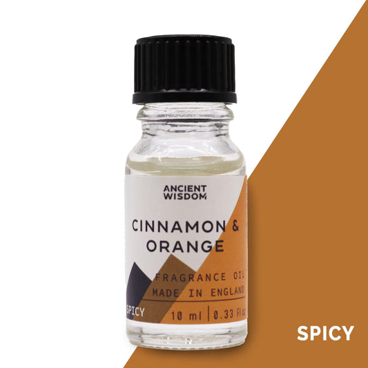 Frasco de vidrio de 10ml con aceite aromático de canela y naranja, tapa negra y etiqueta minimalista en tonos tierra.
