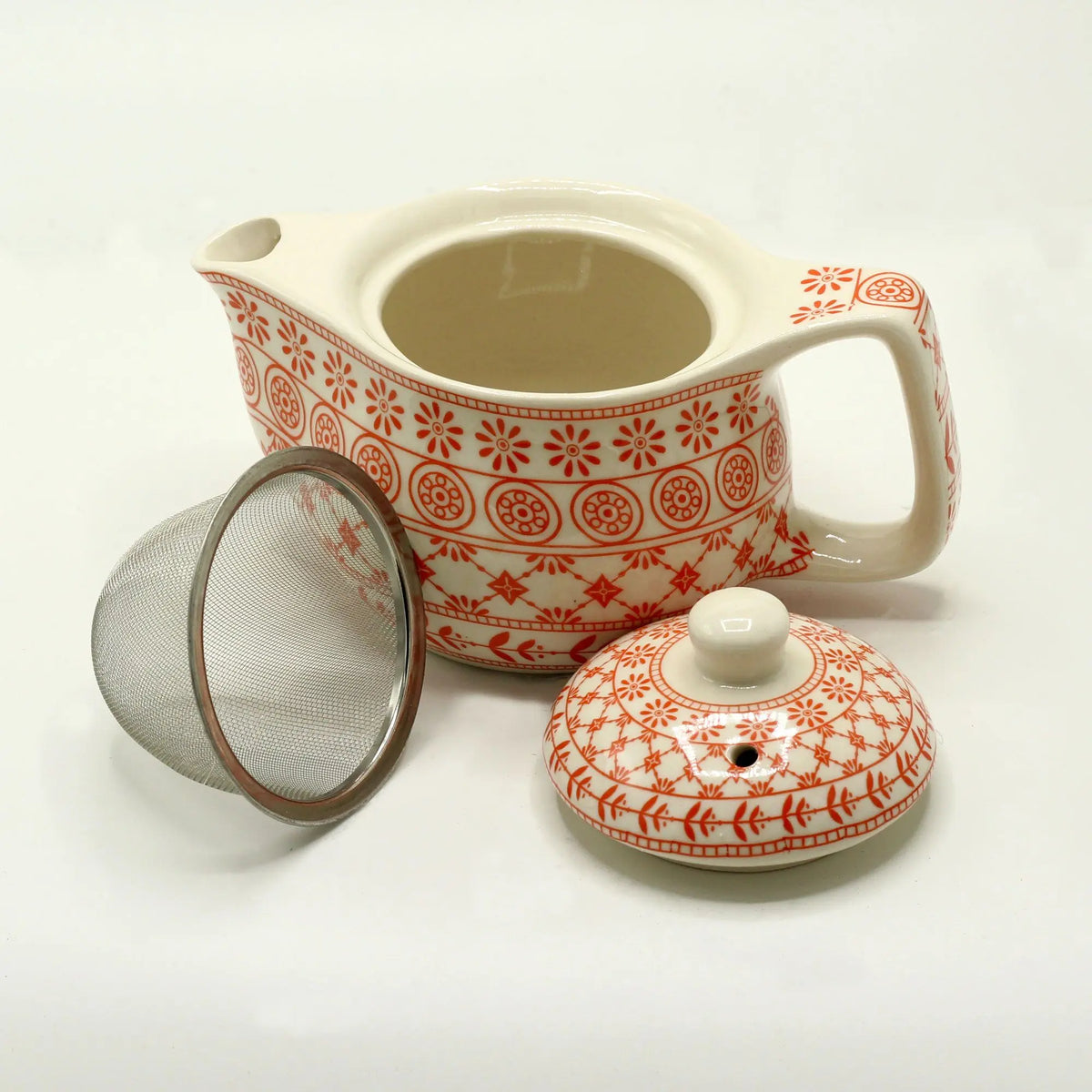 Tetera de cerámica color crema con estampado floral ámbar, incluye tapa y colador de metal. 350ml.