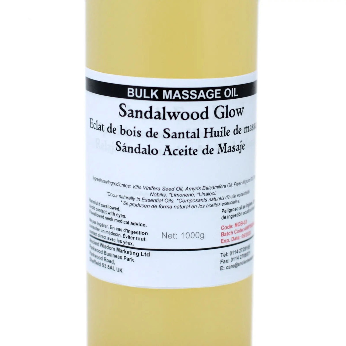 Envase cilíndrico de plástico con 1kg de aceite de masaje amarillento y etiqueta informativa en varios idiomas.