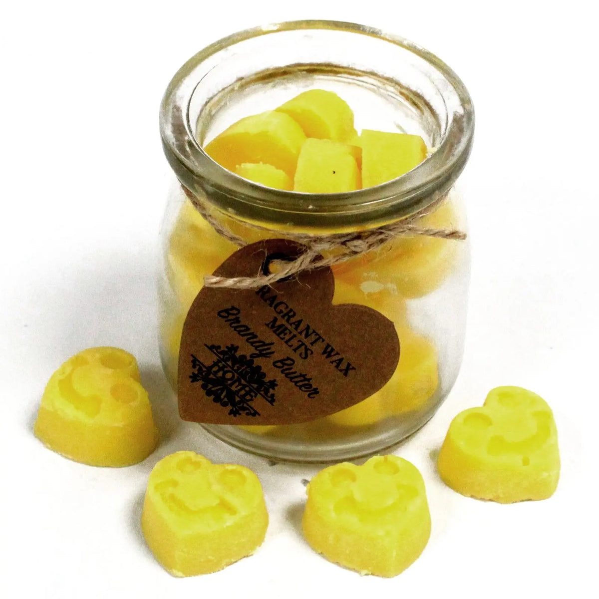 Frasco de cristal con pastillas de cera de soja amarillas con forma de carita sonriente y etiqueta de papel en forma.