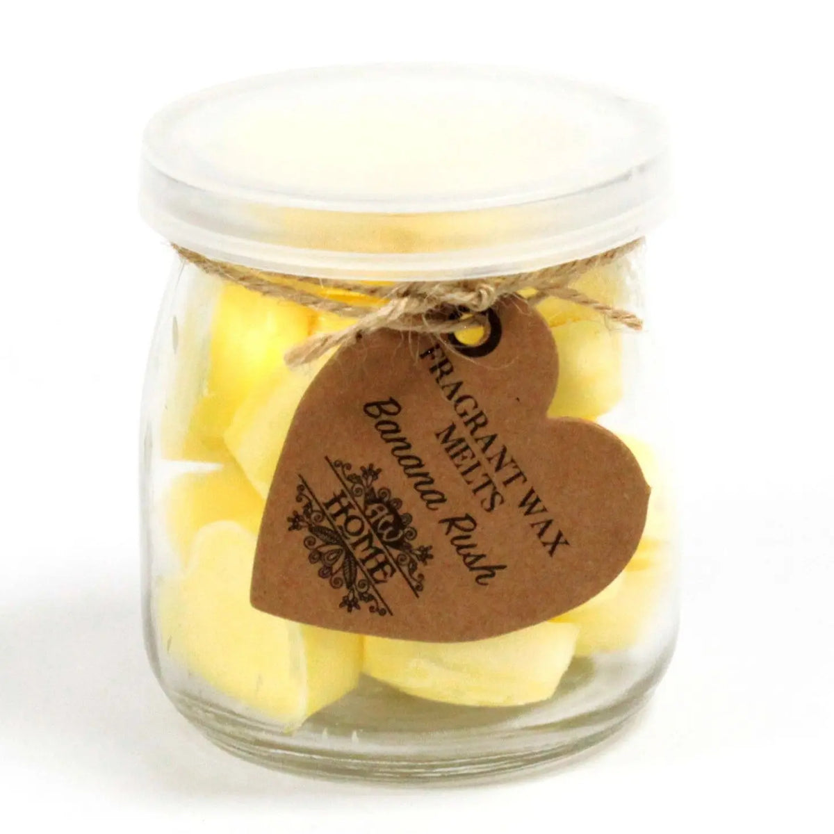 Frasco de cristal con tapa conteniendo figuras de cera amarillas, adornado con una etiqueta de cartón en forma de corazón.