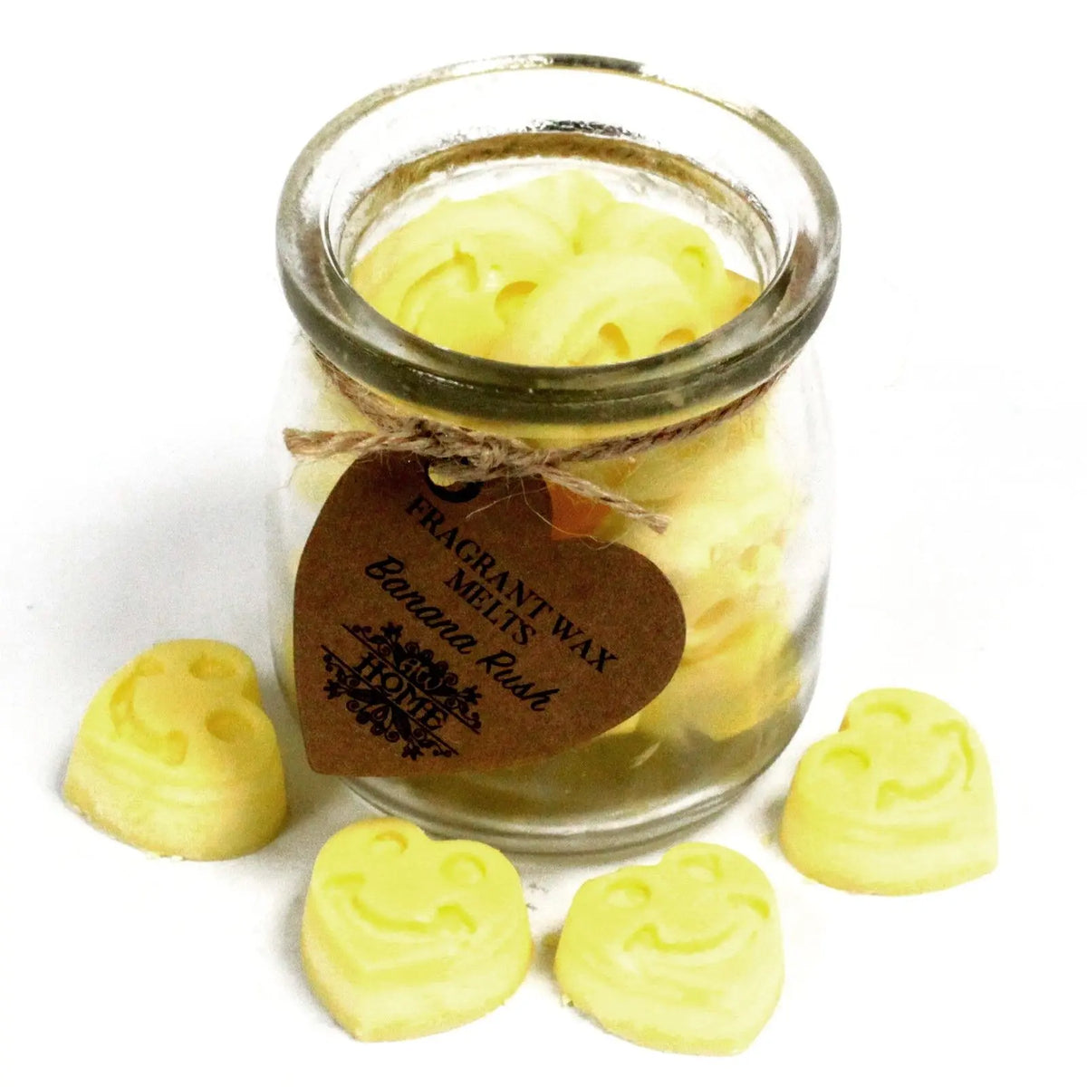 Frasco de vidrio con pastillas de cera de soja amarillas con forma de corazón sonriente y etiqueta de cartón.