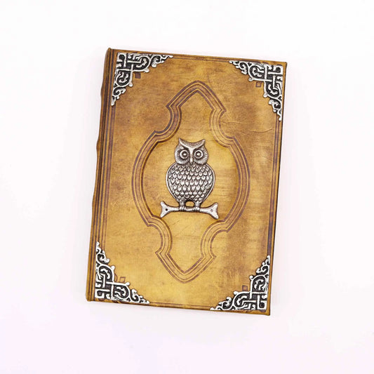 Cuaderno de cuero marrón con diseño en relieve de búho y detalles plateados, estilo vintage.