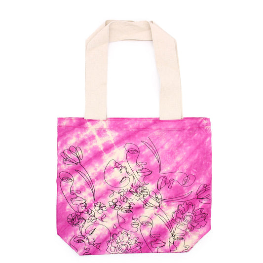 Bolsa de algodón tie dye magenta con estampado de líneas de rostros y flores con asas de color natural