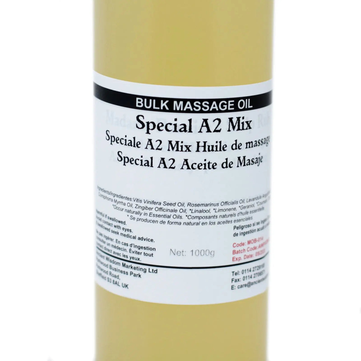 Botella cilíndrica de 1kg con aceite de masaje dorado y etiqueta blanca con texto descriptivo en varios idiomas.