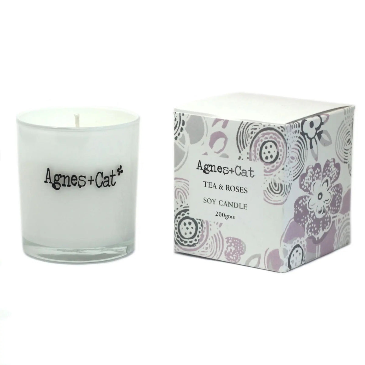 Vela de soja blanca "Tea & Roses" de Agnes + Cat, envase de vidrio y caja decorativa con flores en tonos pastel.