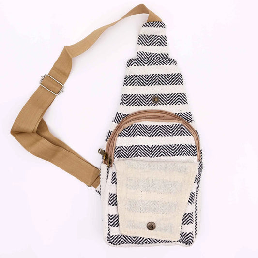 Bolso bandolera de algodón con patrón de rayas zigzag blanco y negro, bolsillo frontal y correa ajustable color beige.