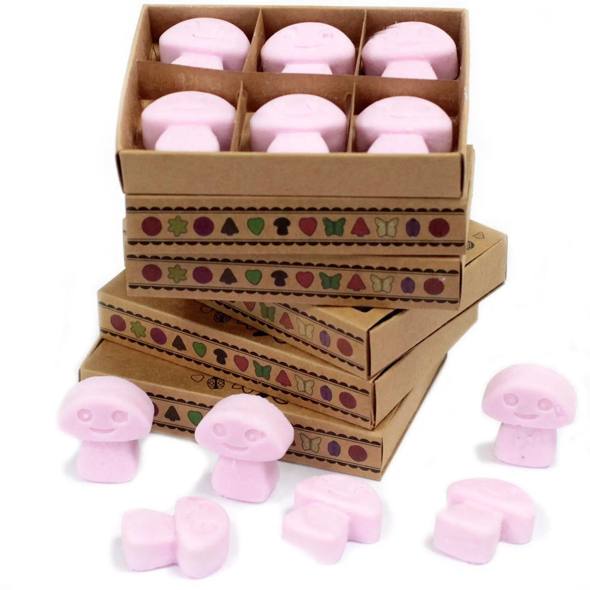 Caja de cartón con 6 ceras de soja rosas en forma de seta; otras ceras sueltas descansan sobre un fondo blanco.