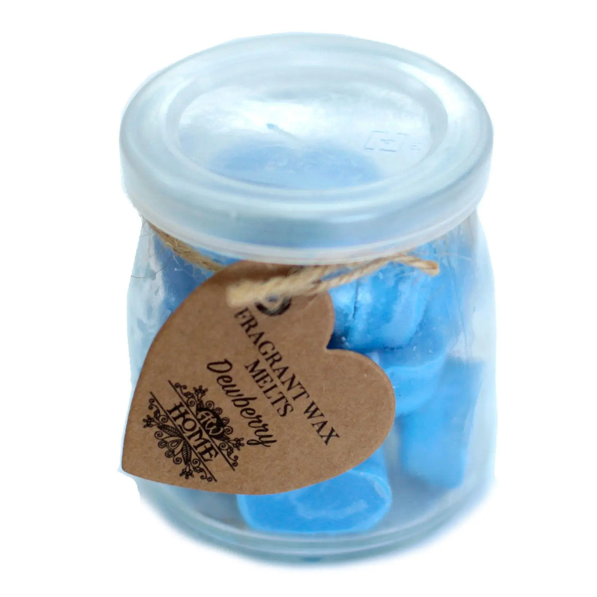 Frasco de vidrio con tapa conteniendo trozos de cera azul y una etiqueta de cartón en forma de corazón.