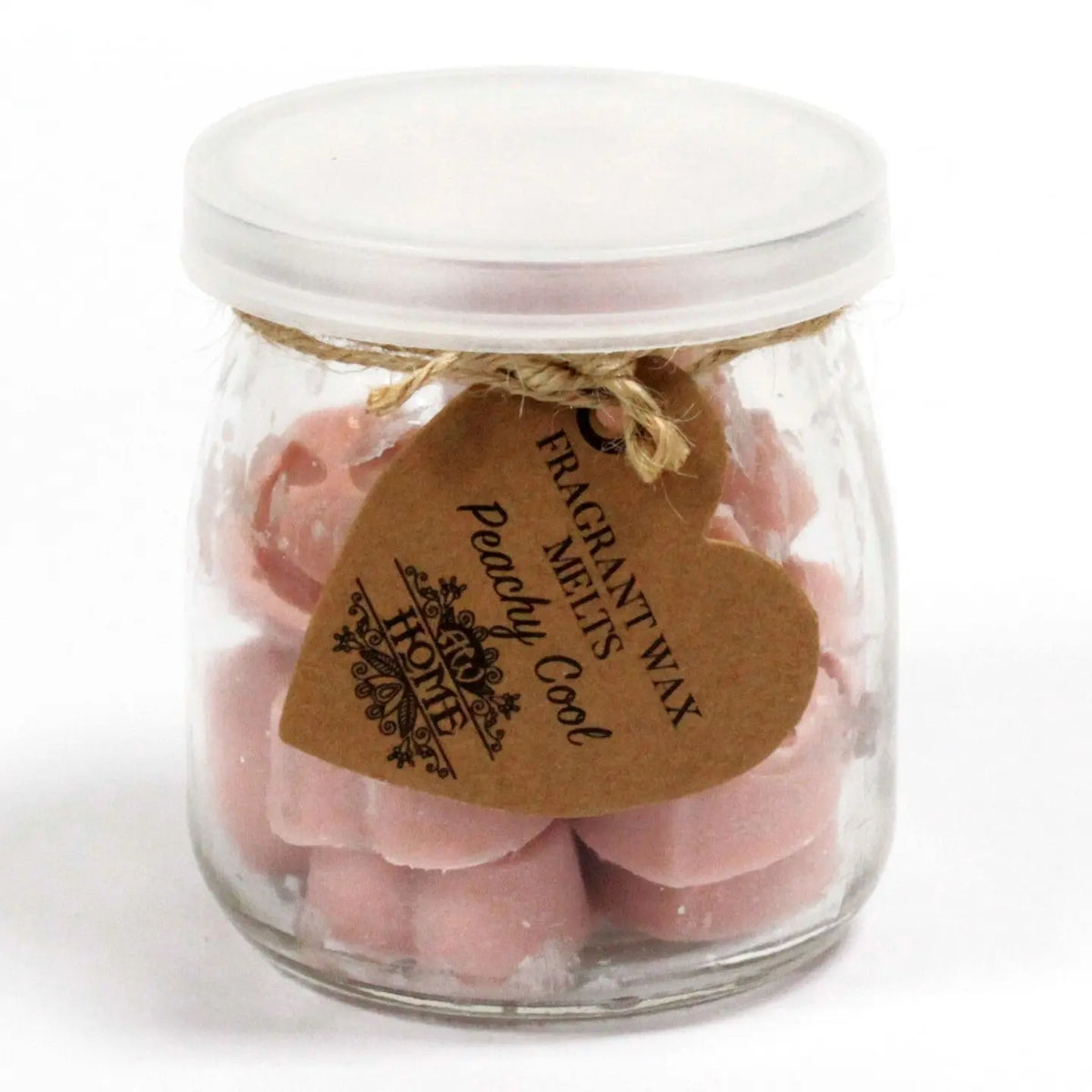 Frasco de vidrio con tapa blanca lleno de pastillas de cera de soja color rosa, con etiqueta de cartón en forma de corazón.