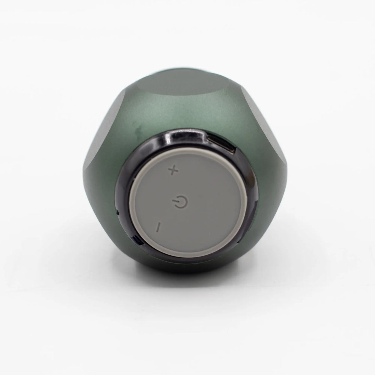 Altavoz Bluetooth mini de color verde oliva, forma redondeada y panel de control circular gris con iconos.