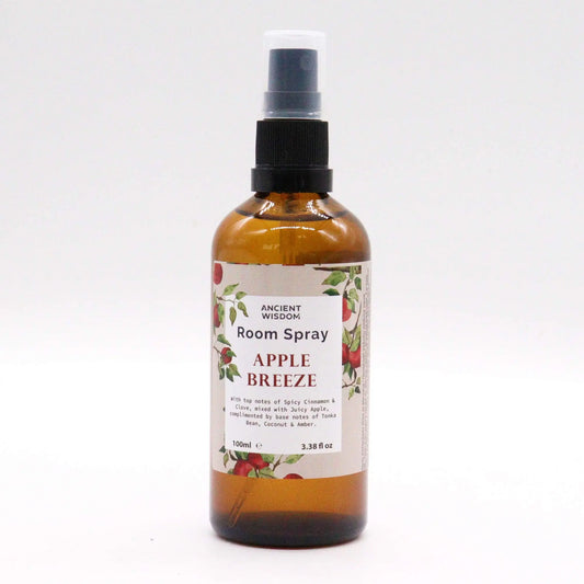 Spray de 100 ml en frasco de vidrio ámbar con etiqueta decorada con manzanas y atomizador negro sobre fondo blanco.