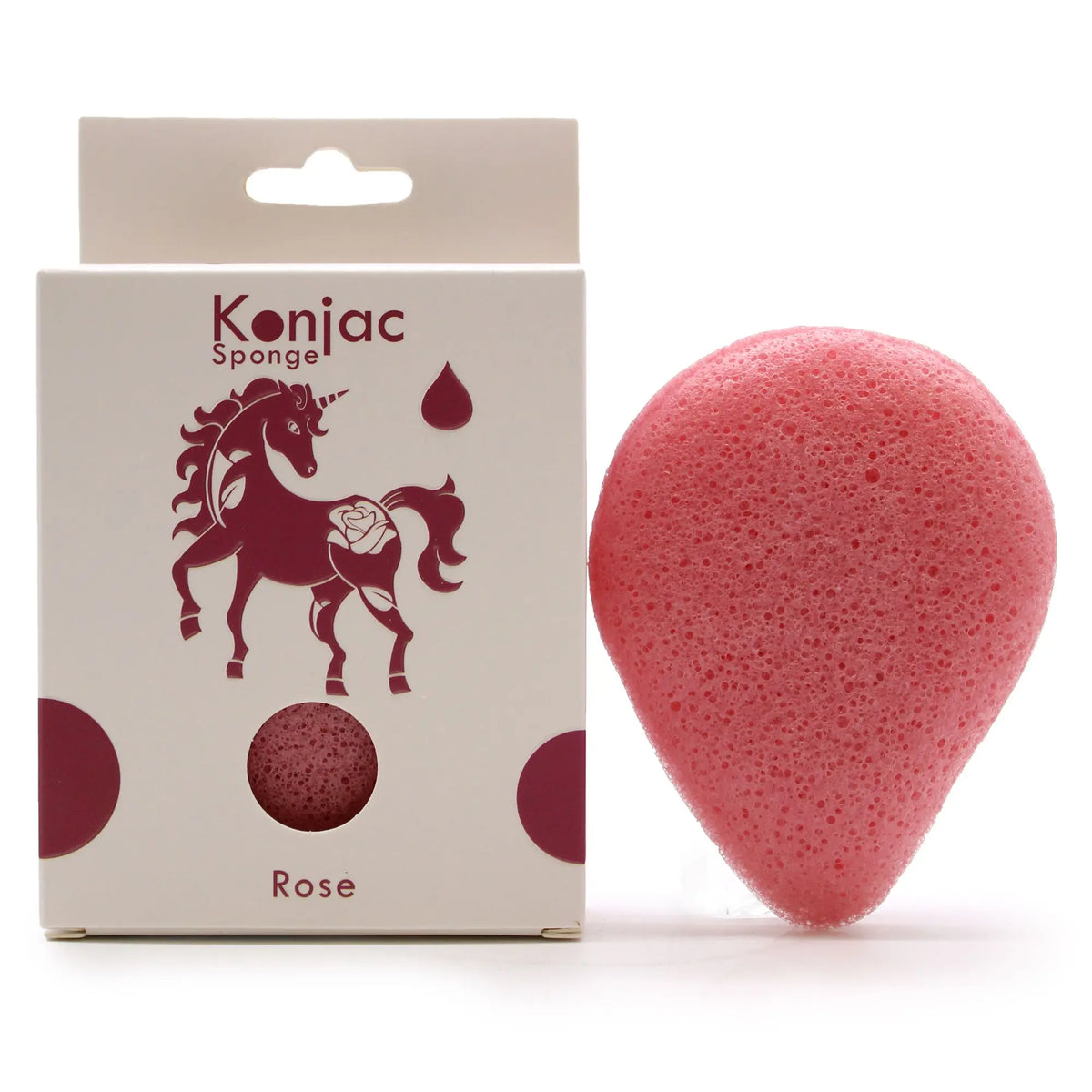 Esponja facial de konjac rosa en forma de gota junto a su caja blanca con diseño de unicornio.