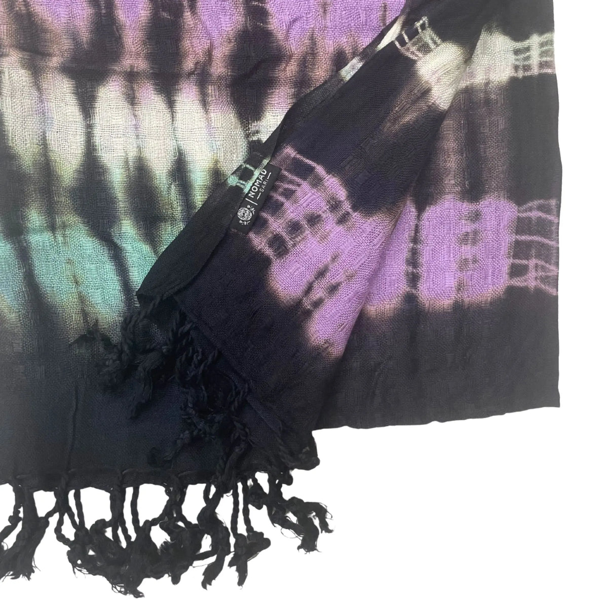 Estola de tela ligera con estampado tie-dye de rayas moradas, negras y verdes, acabado con flecos en los extremos.