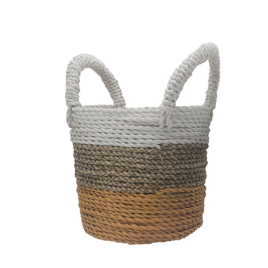 Cesta de algas trenzadas con diseño de tres franjas en blanco, natural y naranja y dos asas superiores rígidas