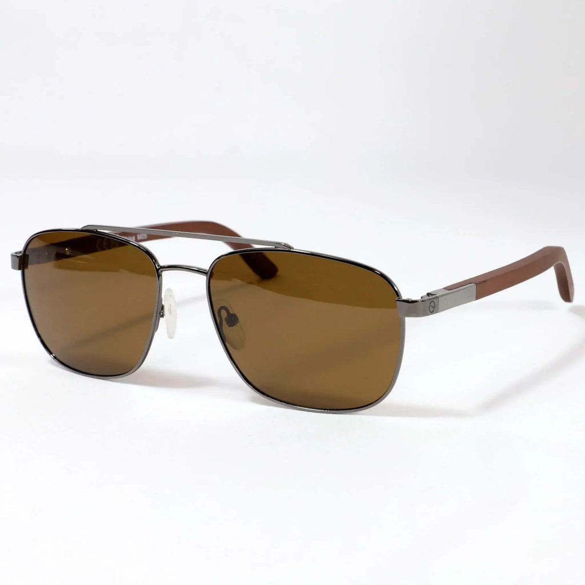 Gafas aviador con montura metálica gris, lentes marrones y patillas de madera sobre fondo blanco.