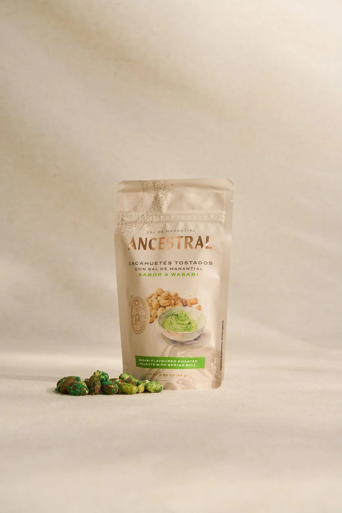 Stand-up pouch of wasabi-coated roasted peanuts with spring salt, beside a small pile of bright green coated peanuts.