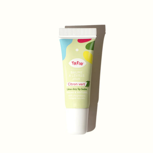 Lime day lip balm in a light green squeezable tube with colorful abstract shapes and Trew branding.