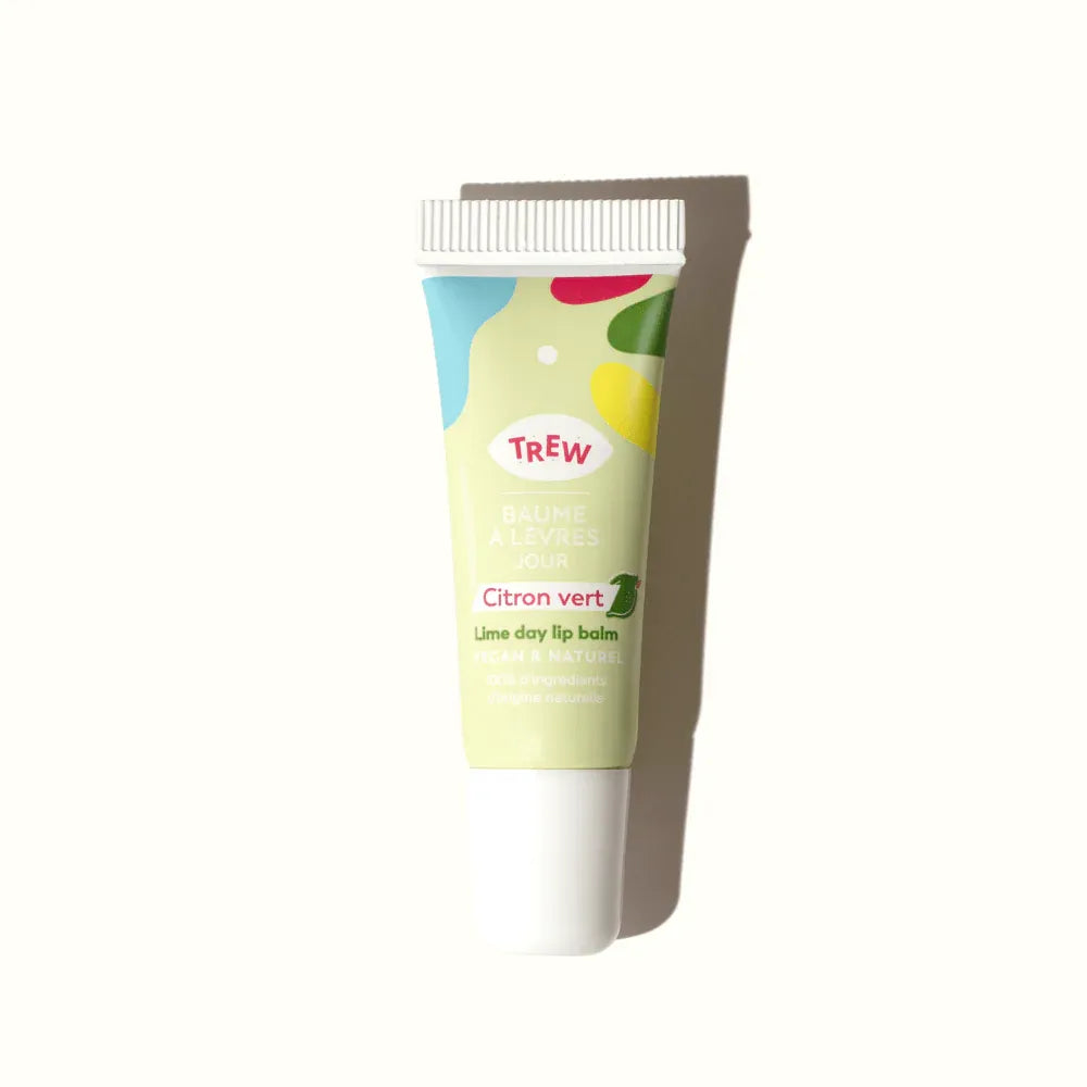 Lime day lip balm in a light green squeezable tube with colorful abstract shapes and Trew branding.