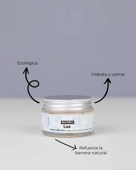 Tarro de crema LUA de Banbu con tapa metálica. Etiqueta con burbujas. Flechas indican beneficios: ecológica y calmante.