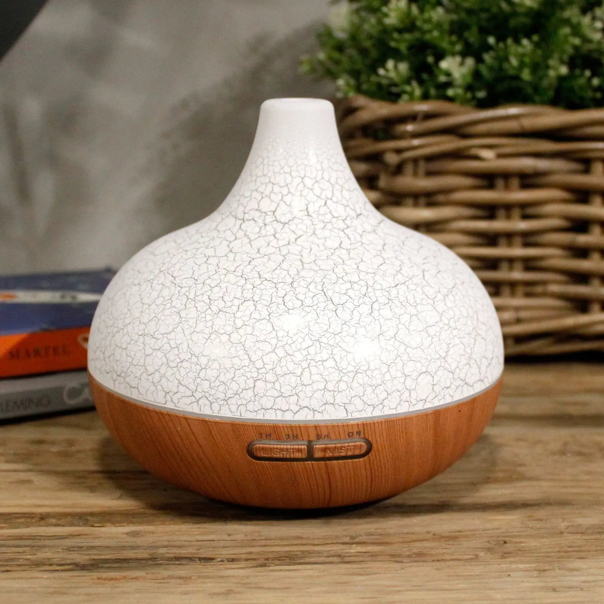 Difusor Santorini blanco con textura agrietada y base de madera, con botones de control integrados y diseño elegante.
