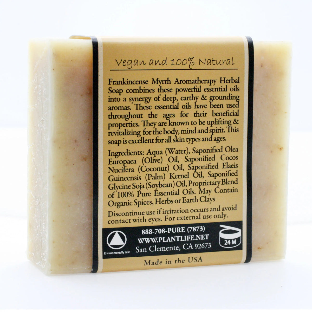 Rectangular bar of light beige natural soap with a paper wrap featuring product details in black text.