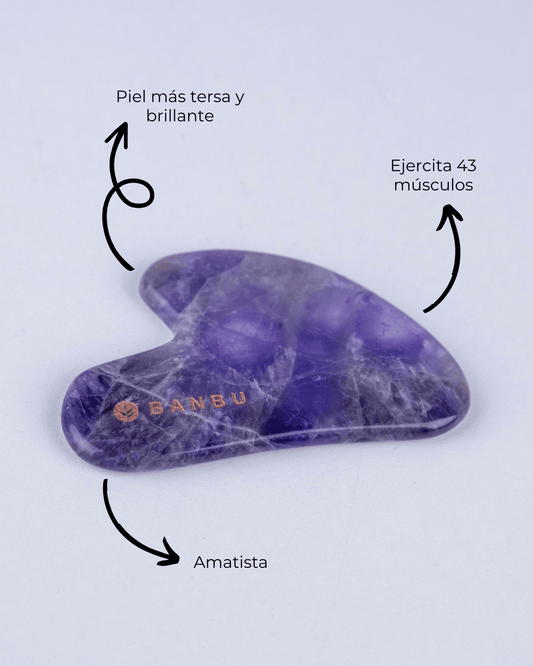 Gua Sha de amatista morada de BANBU con forma de corazón, superficie lisa y brillante sobre fondo blanco.
