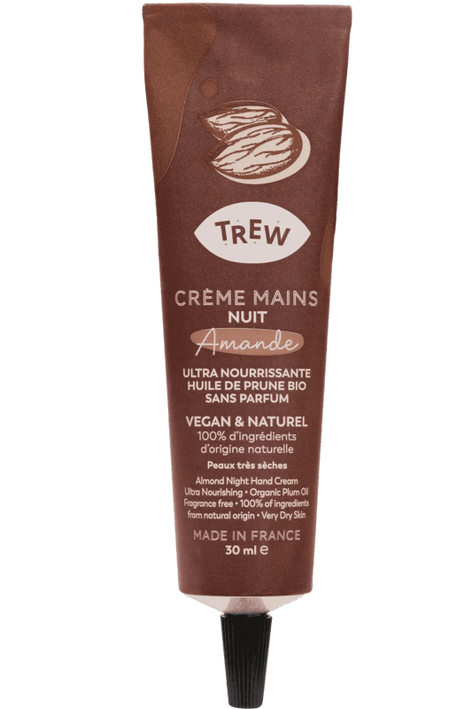 A brown squeeze tube of almond night hand cream by Trew, featuring text details on an almond-shaped label.