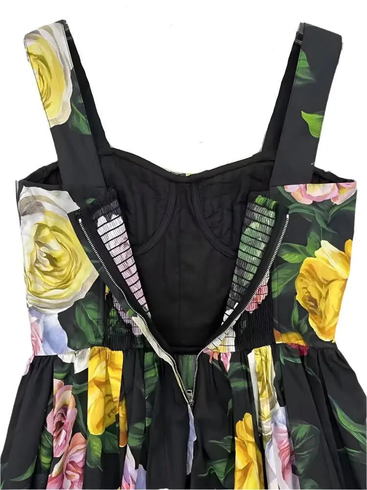 Black floral dress with yellow and pink roses, zip closure, and smocked back detail. Elegant summer style.