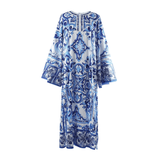 Blue and white patterned maxi dress with long sleeves and intricate tile designs, perfect for warm-weather occasions.
