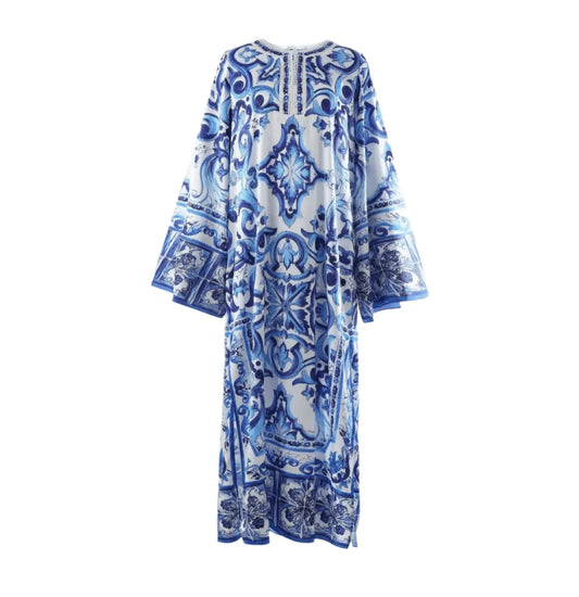 Blue and white patterned maxi dress with long sleeves and intricate tile designs, perfect for warm-weather occasions.