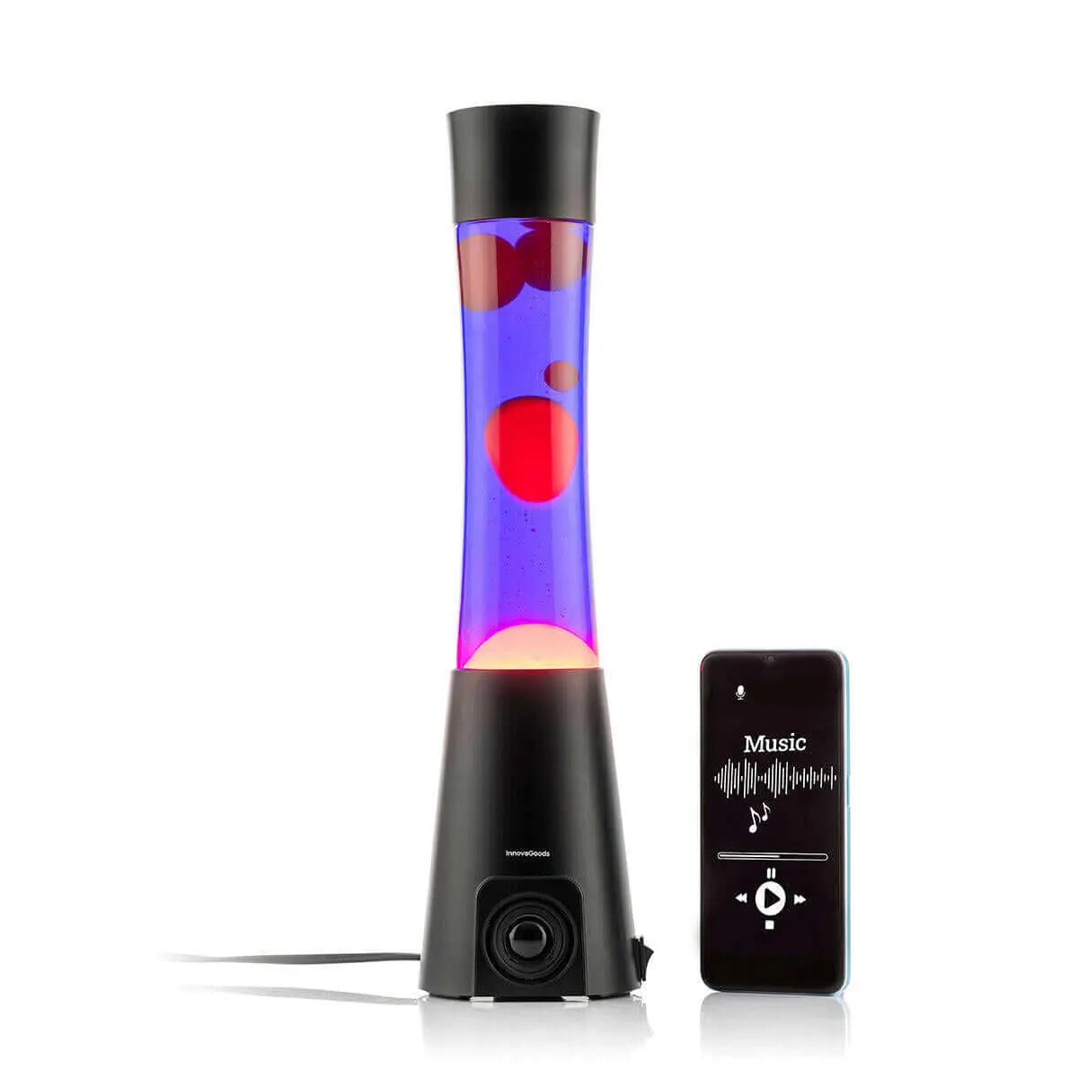 Lámpara de lava con base de altavoz negro, líquido morado y burbujas rojas junto a un smartphone reproduciendo música.