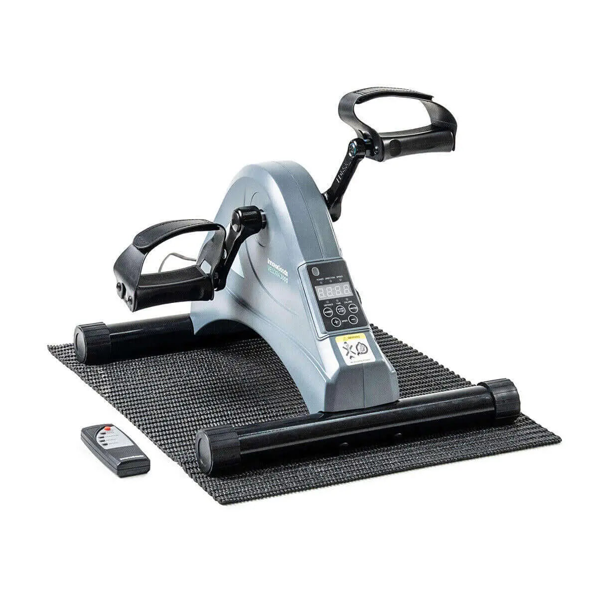 Pedaleador eléctrico gris con pantalla digital, pedales negros, base antideslizante y mando a distancia inalámbrico.