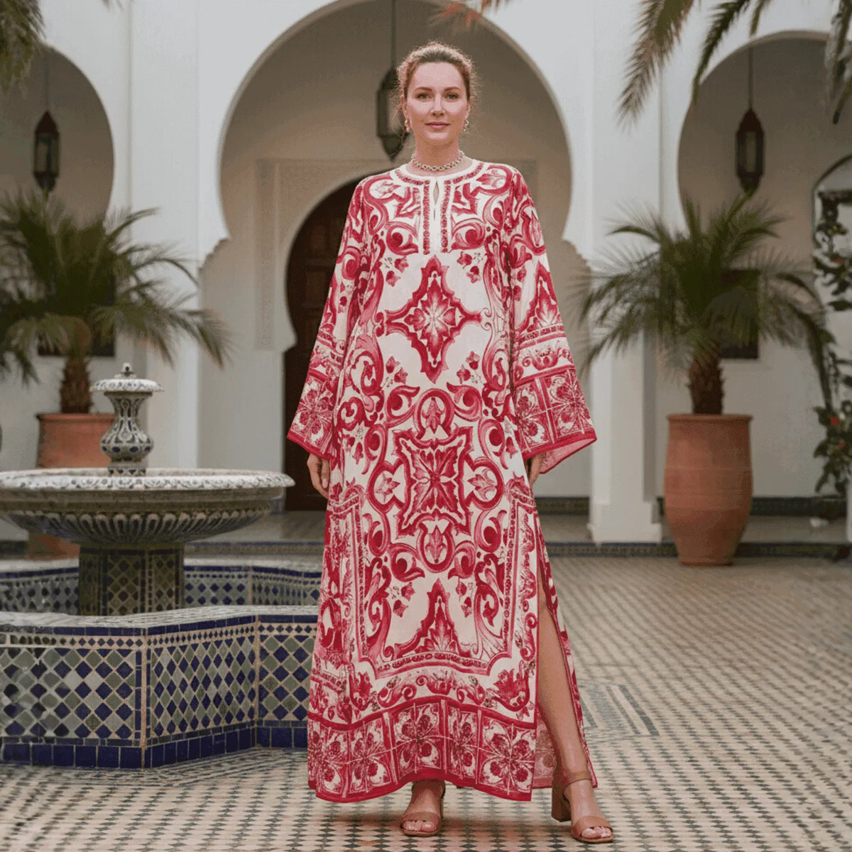 Red and white patterned kaftan dress, featuring long sleeves and side slits, perfect for summer occasions.