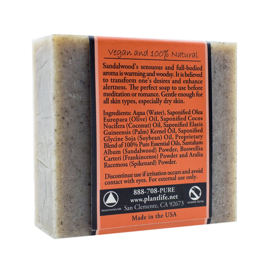 Rectangular Sandalwood bar soap wrapped in an orange paper label featuring product details and ingredient list.