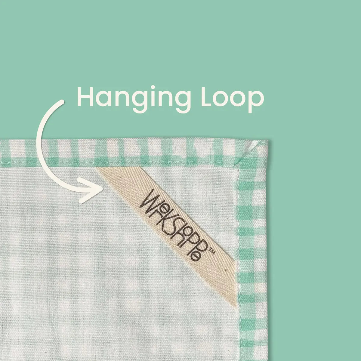 Green and white gingham cotton tea towel featuring a cream-colored fabric hanging loop with the WerkShoppe logo.