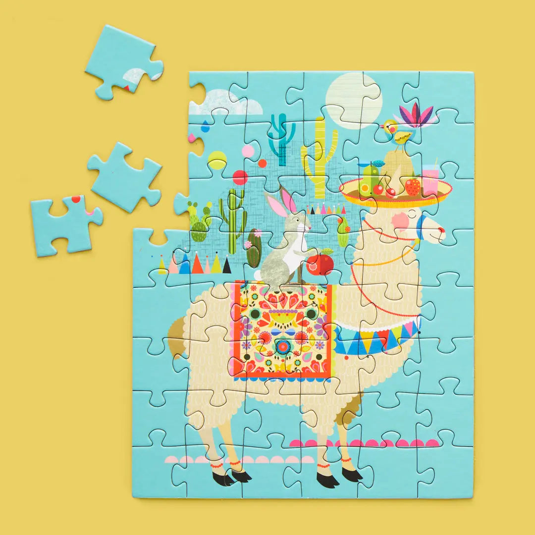 48-piece jigsaw puzzle featuring a whimsical llama with a fruit platter, bunny, and cacti on a light blue background.