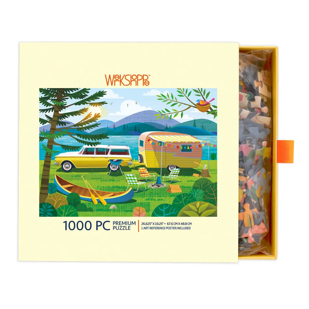 Happy Camper 1000-piece puzzle box featuring a retro camping scene with a station wagon, vintage trailer, and canoe.