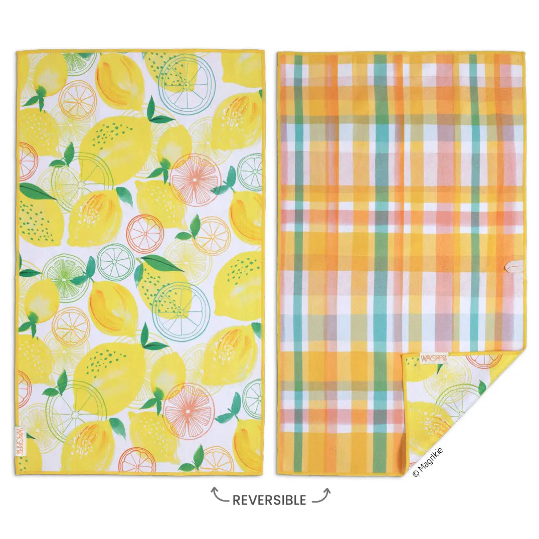 Reversible microfiber dish towel with lemon pattern on one side and yellow, teal, and white plaid on the other.
