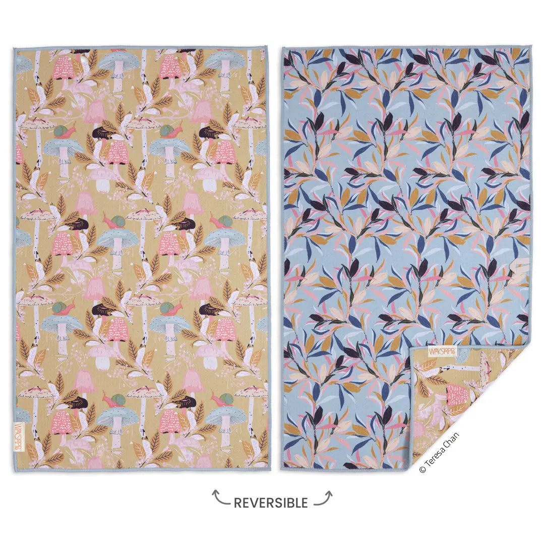 Reversible microfiber dish towel with yellow mushroom and snail pattern on one side and blue leaf print on the other.