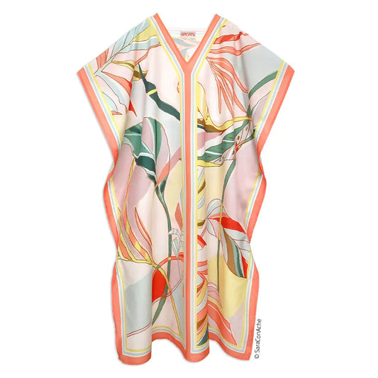 V-neck caftan with a pastel tropical leaf print, coral trim, and loose, flowy silhouette on a white background.