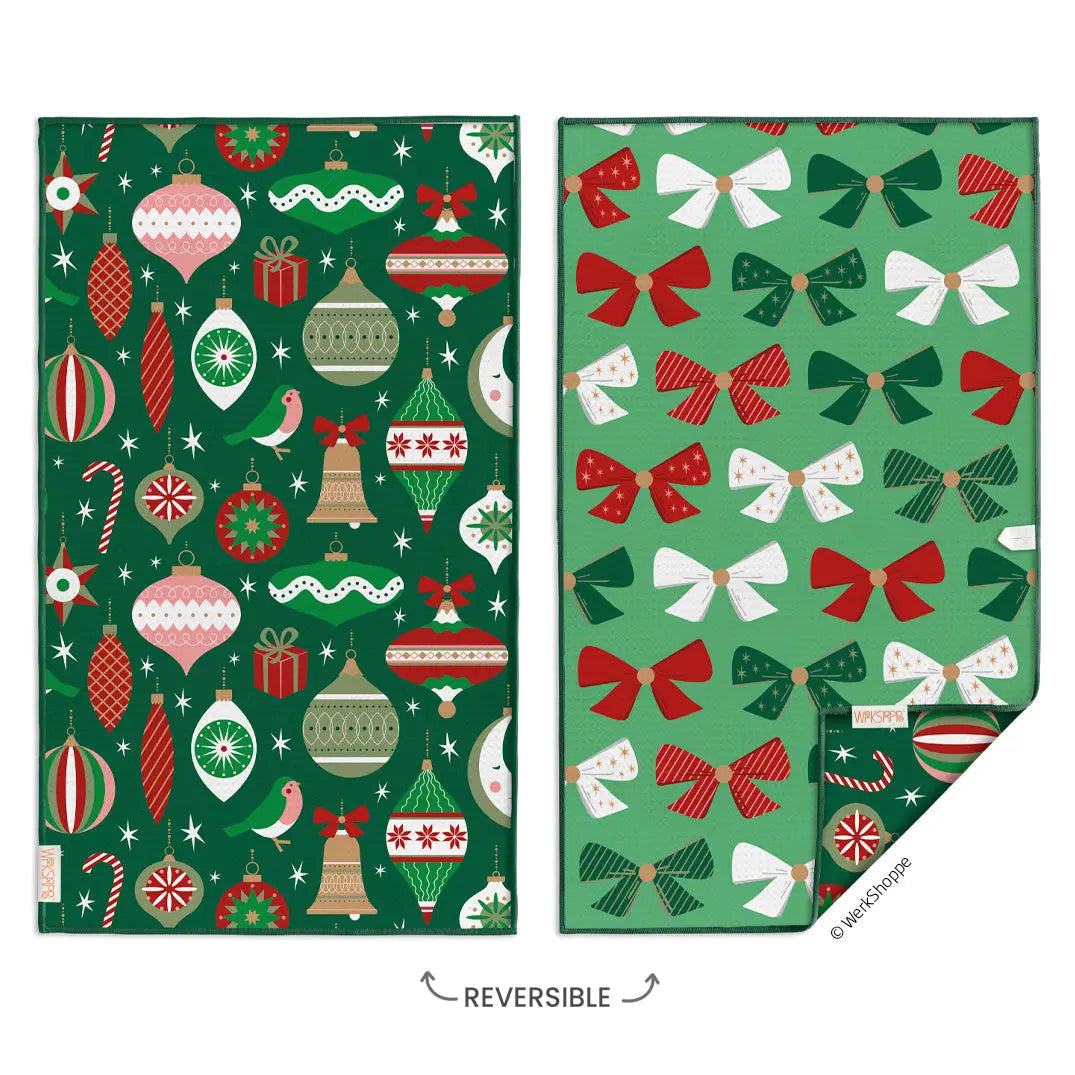 Reversible microfiber towel featuring a dark green ornament pattern on one side and light green bow print on the other.