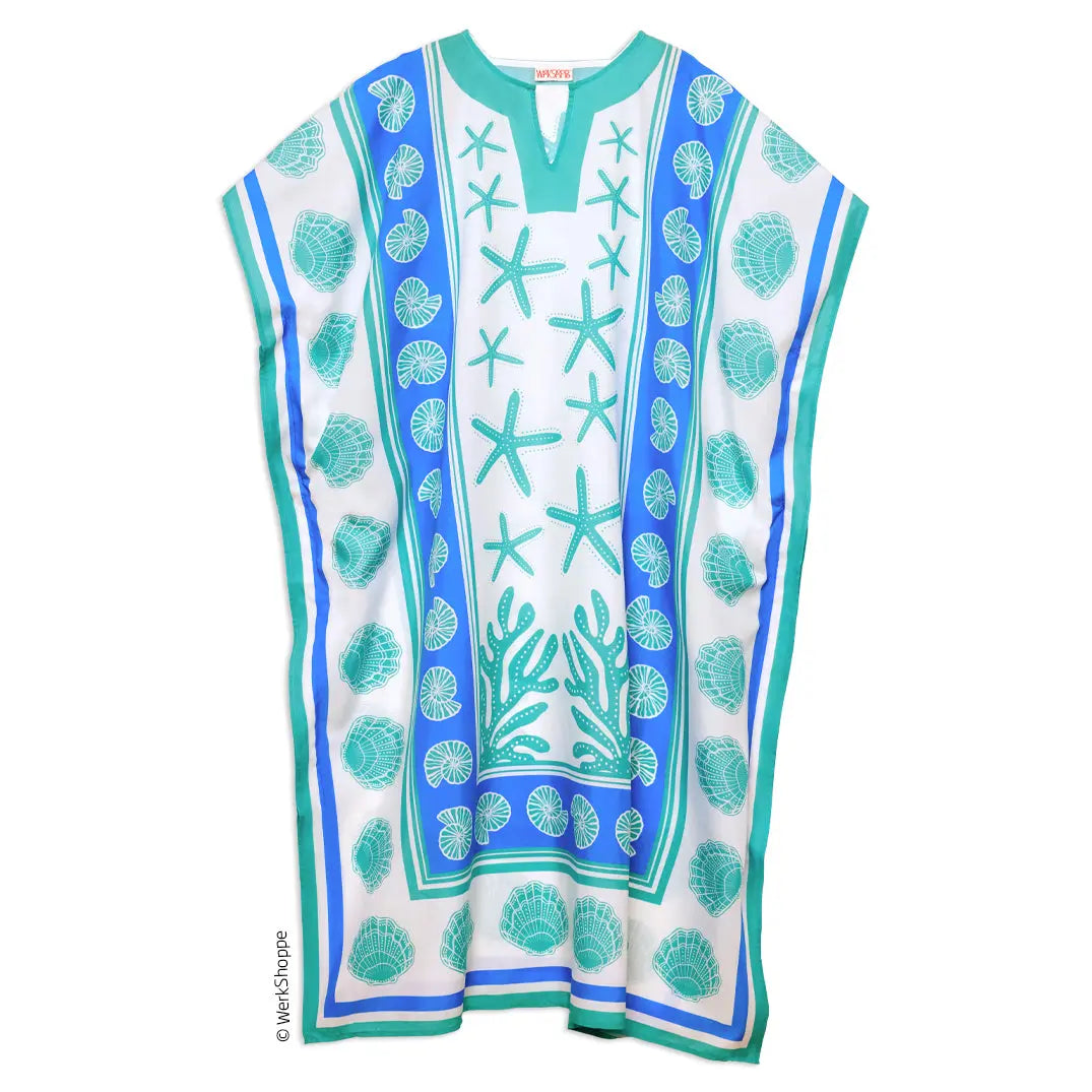 White caftan with teal and blue starfish, shell, and coral print, featuring a notched V-neckline and loose fit.