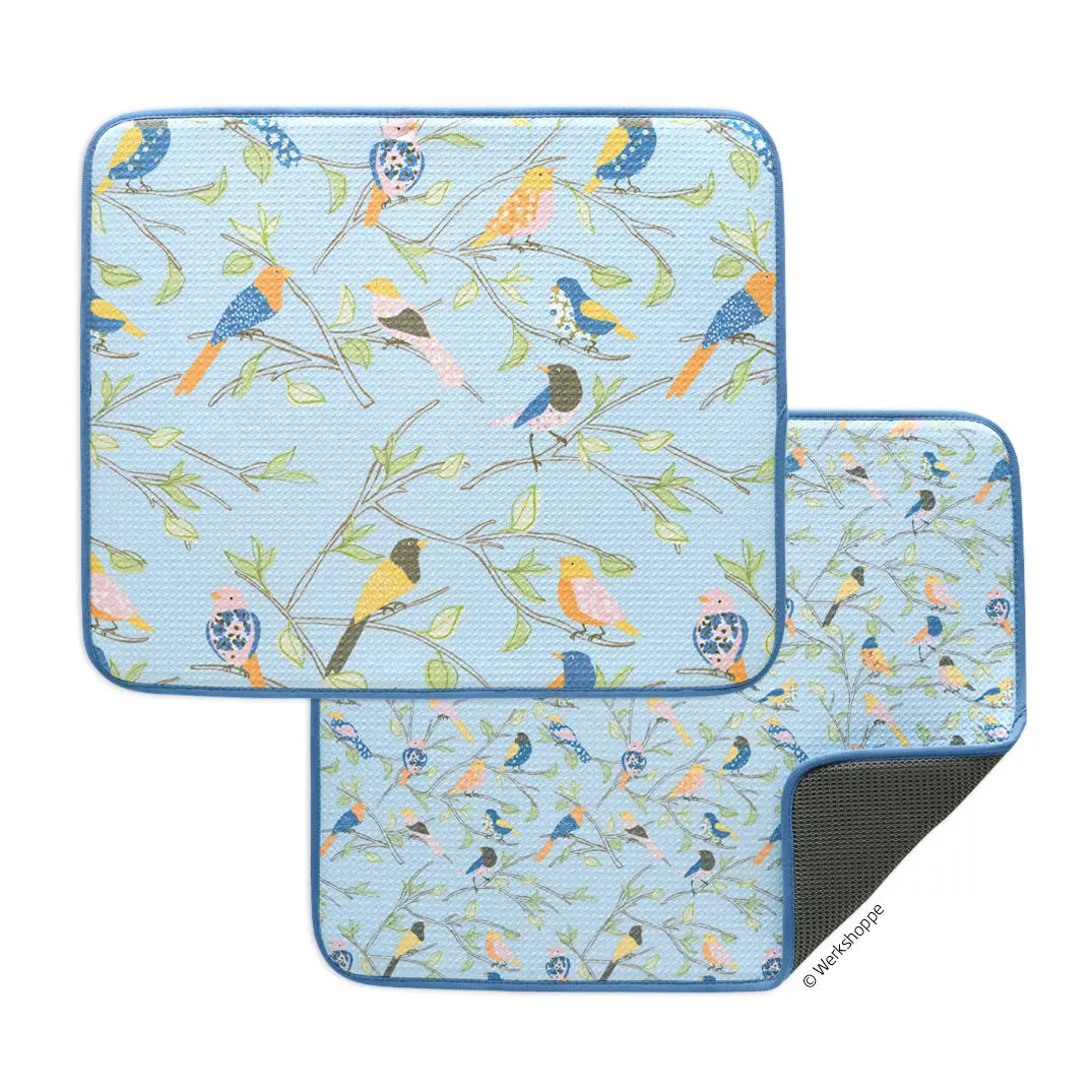 Two rectangular dish drying mats with a light blue background, featuring a colorful bird and branch pattern.