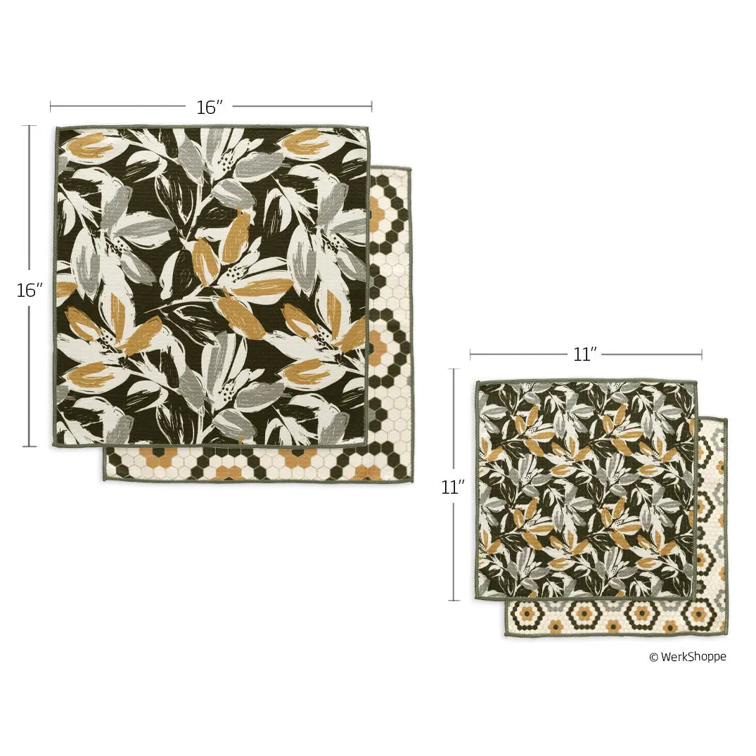 Two reversible towels featuring a botanical leaf print on one side and a gold-and-black hexagon pattern on the other.