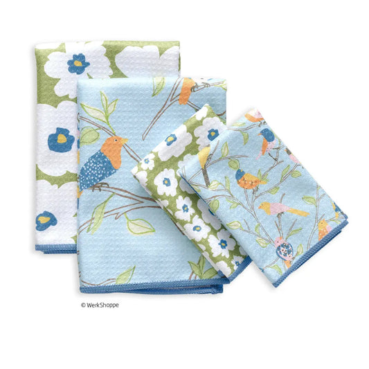 Waffle-knit towels featuring a light blue and olive green floral print with colorful finches on branches.