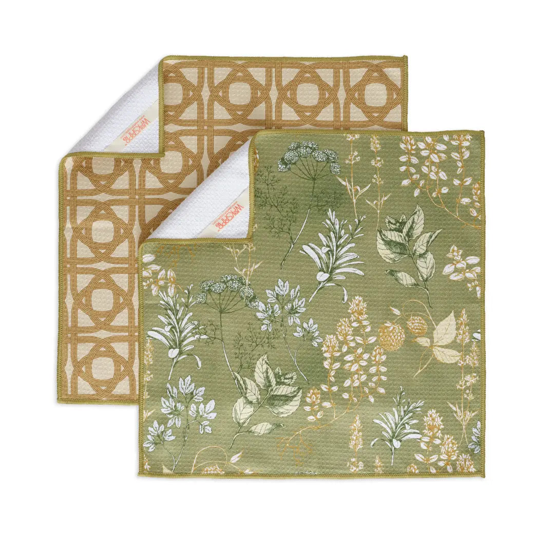Two square, textured kitchen towels: one with green botanical herb prints, one with a tan geometric circular pattern.