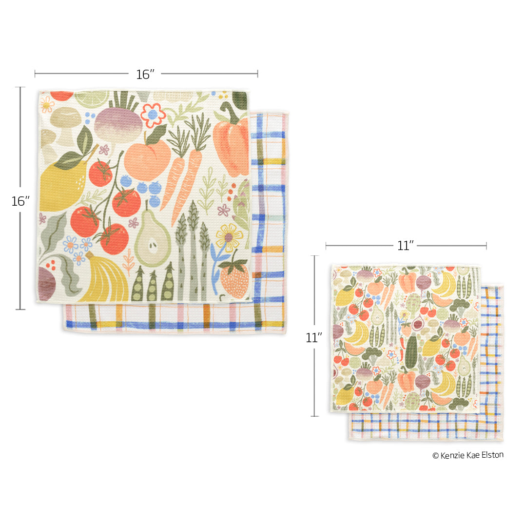 Two towels with colorful fruit and vegetable patterns on the front and a blue-and-yellow plaid print on the back.