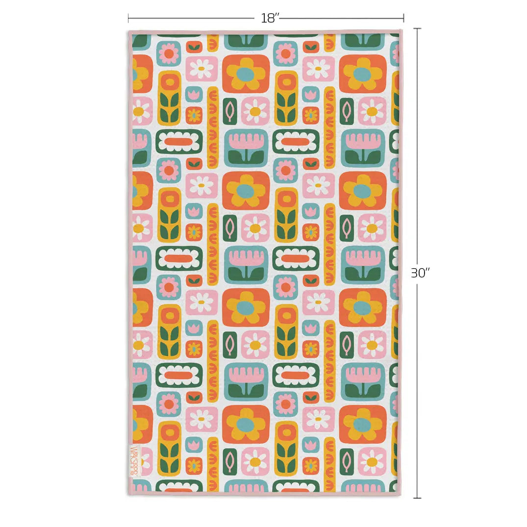 Rectangular microfiber towel with a retro, colorful pattern of daisies, tulips, and geometric shapes in 18" x 30".